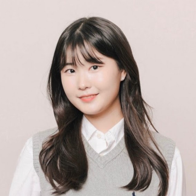 Headshot of Jasmine, a Korean woman wearing a white collared shirt under a light gray sweater vest, smiling softly against a plain light pink background.